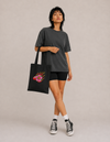 Model carrying the Flower cotton tote bag by Mojo Circus