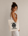 Model carrying the Holding Space cotton tote bag by Mojo Circus