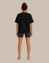 Model wearing the Meditation Zen Beach tee by Mojo Circus, back view