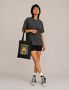 Model carrying the Meditation Zen Beach cotton tote bag by Mojo Circus