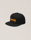 Phangan Paradise cap by Mojo Circus, three-quarter view from the left, showing the flames graphic on the front panel.
